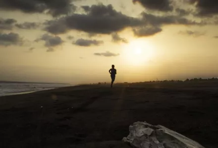 Person running into the sunset. 