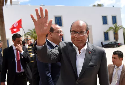 Tunisian former president Moncef Marzouki arrives to take part in an anti-extremism march, in Tunis, Sunday, March 29, 2015.