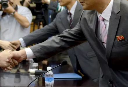 A North Korean diplomat wearing the double portrait lapel pin.