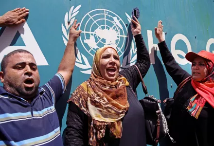 Palestinians demonstrate outside the UNRWA Gaza Headquarters against cuts and the possibility of delaying the school year due to severe deficit in the agency’s budget, in Gaza City, Monday, Aug. 10, 2015.