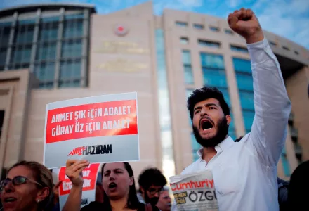 Journalists and activists gather outside the court in Istanbul, Friday, July 28, 2017, protesting against the trial of journalists and staff from the Cumhuriyet newspaper, staunchly opposed to President Recep Tayyip Erdogan, accused of aiding terror organisations.