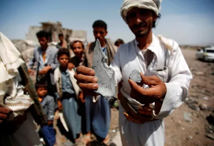 A man shows fragments of a bomb from the rubble of houses destroyed by a Saudi-led airstrike on the outskirts of Sanaa, Yemen, Wednesday, June 3, 2015.
