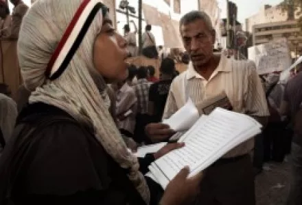 Activist distributing flyers of the movement during the demonstration on Tahrir Square to defend the revolution in Cairo, Egypt.