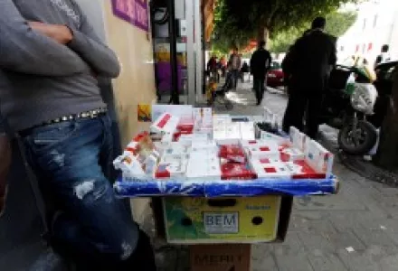 Issam Khedri, 29, eldest brother of cigarette vendor Adel Khedri, tends to the cigarette stand of his late brother in the Tunisian capital, Tunis. Adel set himself on fire outside the Municipal Theater in the heart of Tunis on March 12, 2013.