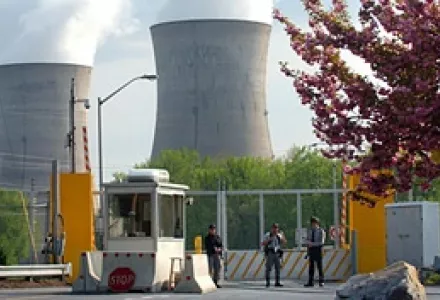Armed personnel stand in front of the security gate leading to Three Mile Island nuclear power plant in Harrisburg, PA.