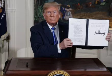 President Donald Trump shows a signed Presidential Memorandum after delivering a statement on the Iran nuclear deal from the Diplomatic Reception Room of the White House, Tuesday, May 8, 2018, in Washington, D.C.