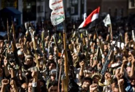 Shiite rebels known as Houthis hold up their weapons as they chant slogans during a protest to denounce the Saudi aggression in Sanaa, Yemen.