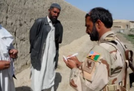 Attacking the Network: A member of the Afghan Local Police interviews villagers in Paktika Province, Afghanistan, April 2013.