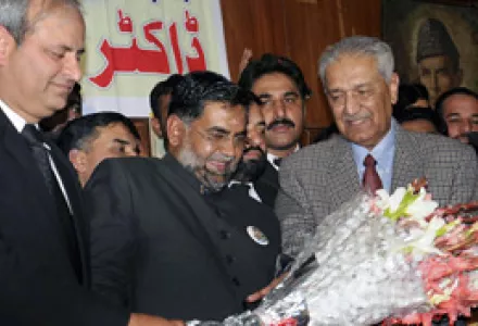Pakistani lawyers present flowers to disgraced Pakistani nuclear scientist A. Q. Khan, right, upon his arrival to address an event in Rawalpindi, Pakistan, Jan. 9, 2010. Khan helped Pakistan develop nuclear weapons.