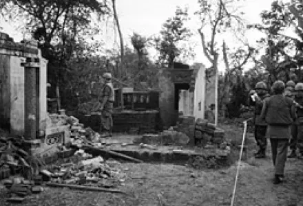 U.S. soldiers look over the remains of a home in My Lai, South Vietnam, Jan. 8, 1970