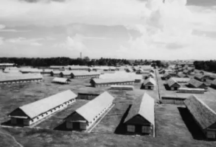This is one of the many evacuee villages built inland back of Singapore, for emergency occupancy by Malays living near the coast. This picture was taken in the summer of 1941.
