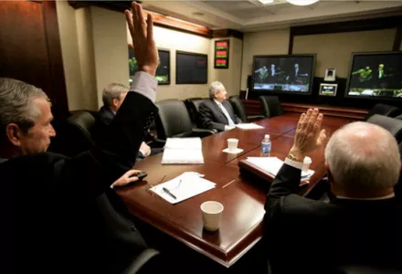 President George W. Bush and Vice President Dick Cheney wave from the Situation Room of the White House, March 19, 2007, as they're joined in a video teleconference by Prime Minister Nouri al-Maliki of Iraq.