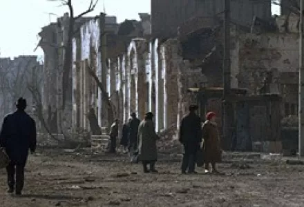 Residents of Grozny venture out to view the devastated city center, February 13, 1995.