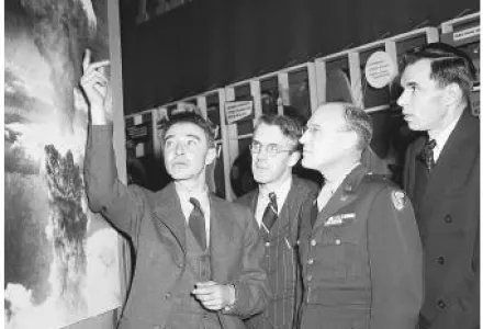 J. Robert Oppenheimer, Professor. H. D. Smyth, General Nichols, and Glenn Seaborg in 1946 looking at a photograph of the atomic blast at Nagasaki