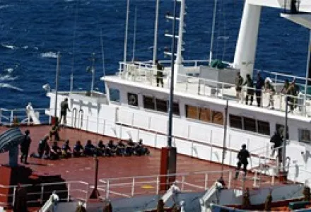 Japanese Coast Guards detain members of the crew of a U.S. military supply ship after boarding the ship by helicopter during "Exercise Pacific Protector"--one-day maneuvers aimed at demonstrating their ability to board ships suspected of smuggling WMD.
