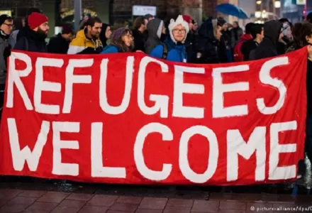 People holding "Refugees Welcome" sign in Germany