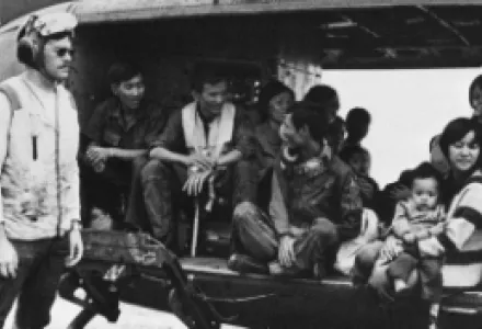 Vietnamese refugees in VNAF Bell UH-1D/H Huey on the flight deck of the aircraft carrier USS Midway (CVA-41) during "Operation Frequent Wind" in the South China Sea, 29 April 1975.