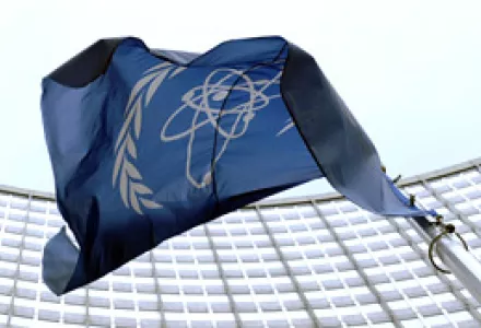The flag of the International Atomic Energy Agency (IAEA) flies in front of the Vienna headquarters at the Vienna International Center on March 27, 2009.