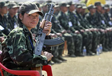 Sgt. Maj. Kave Rongpipi of the Karbi Longri North Cachar Hills Liberation Front (KLNLF) before surrendering her gun to Assam Chief Minister Tarun Gogoi during a disarmament ceremony in Diphu, India, Feb. 11, 2010.