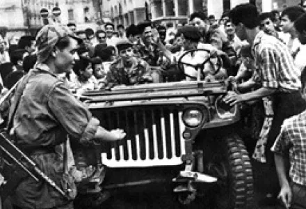 A jeep of the Algerian Liberation Front (FLN) is surrounded by an enthusiastic crowd in Algiers, Algeria, in July 1962. On July 5, 1962, the treaties of independence were signed and Algeria gained independence from France.