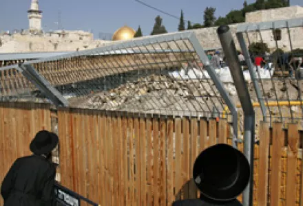 Ultra-Orthodox Jews peer at Israeli Antiquities Authority employees working at the walkway to the Al Aqsa Mosque compound in east Jerusalem's Old City, Feb. 12, 2007. Jerusalem's Jewish mayor has ordered a review of construction work near the holy site.