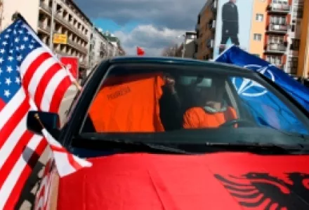 Young boys celebrate the proclamation of independence of Kosovo with U.S. and NATO flags in Mother Teresa Square in Pristina, Feb. 17, 2008.