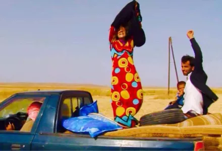 A Kurdish woman taking off the burqa imposed by the Islamic State after escaping into the YPG-controlled area.