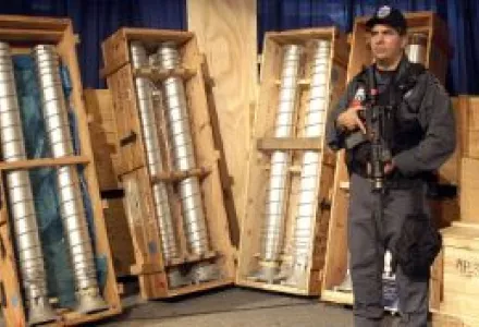 Gas centrifuges for uranium enrichment recovered from the <em>BBC China</em> in Italy, en route to Libya, in 2003. They were later taken to the Y-12 complex in the USA where this photo was taken (with a Y-12 guard also in the photo).
