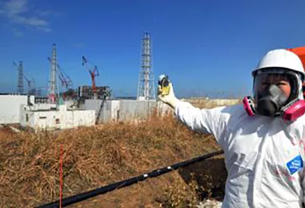 A journalist checks radiation levels near the Fukushima Daiichi nuclear power plant in 2012.