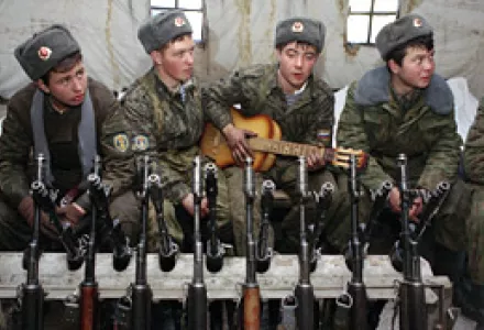 Russian soldiers surround one of their numbers playing a guitar in a tent at the Beslan army base in Ossetia in the North Caucasus, Jan. 25, 1995.