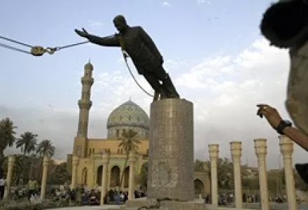 A U.S. Marine watches a statue of Saddam Hussein being toppled in Firdaus Square, in downtown Bagdhad, April 9, 2003.