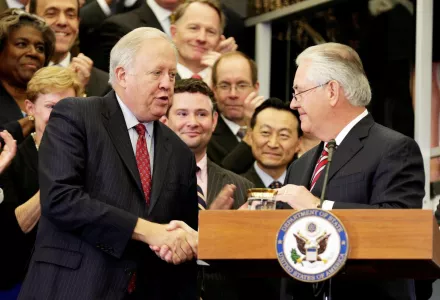 Secretary of State Rex Tillerson shakes hands with then-Acting Secretary of State Tom Shannon 