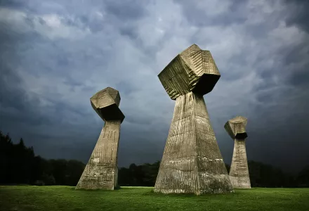 During World War II, German Nazis shot more than ten  thousand residents of Nis and Southeast Serbia on Bubanj hill. After the war, the execution site was transformed into a memorial park, with a monument in the shape of three clenched fists, symbolizing the resistence of men, women, and children who died on the location.