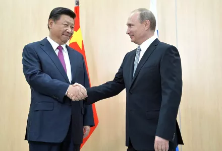Xi Jinping and Vladimir Putin shaking hands at the BRICS Summit, July 8, 2018