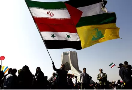 A man waving a giant flag combining the Iranian, Palestinian, Syrian and Hezbollah flags during a celebration at Azadi Square in the Iranian capital Tehran.