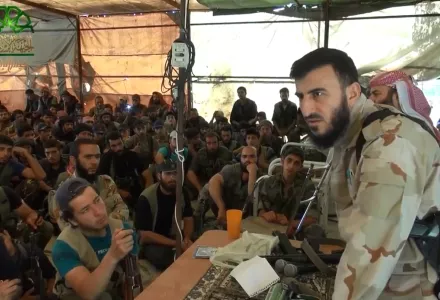 Zahran Alloush, leader of Jaysh al-Islam, speaks to his group's fighters before a battle with Islamic State in Mayda'a, Syria, July 2014