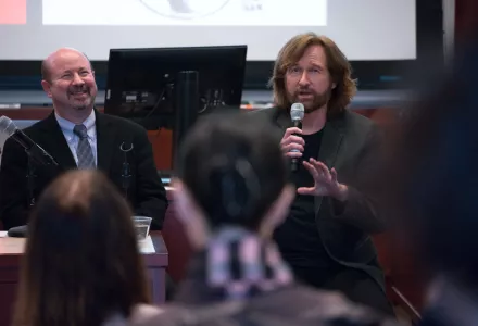 Distinguished Professor of Atmospheric Science at Penn State Michael Mann and Pulitzer Prize-winning editorial cartoonist Tom Toles introduce themselves at the Starr Auditorium at Harvard Kennedy School on Wednesday, February 14, 2018. (Benn Craig)