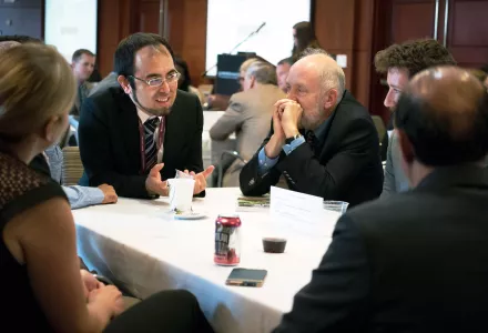 Masahiko Haraguchi (left) talks with the Belfer Center's Matthew Bunn (center) during the Center Orientation.