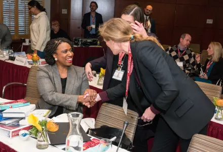 Representative Ayanna Presley and Samantha Power shake hands