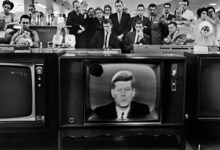 Americans watch President Kennedy speak on television during the Cuban Missile Crisis in 1962.