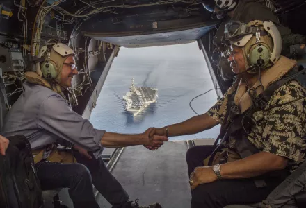 Secretary of Defense Ash Carter (left) and Philippine Secretary of National Defense Voltaire Gazmin (right) shake hands on a Marine Corps V-22 Osprey as they depart the USS Stennis after touring the aircraft carrier as it sails the South China Sea April 15, 2016.