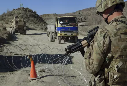 In this Dec. 1, 2011, file photo, a U.S. soldier with Apache Company of Task Force 3-66 Armor, out of Grafenwoehr, Germany, stands guard at a police checkpoint at Gulruddin pass in Sar Hawza district of Paktika province, south of Kabul, Afghanistan.