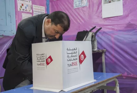 A Tunisian policeman dressed in civilian clothing casts his vote April 29 during municipal elections at a polling station for the police and military in Tunis. (Hassene Dridi/AP)
