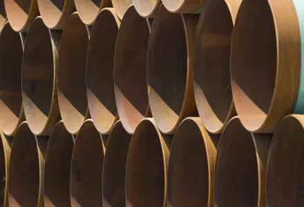 stacks of coated steel pipes