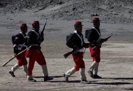 Bolivian soldiers, dressed in costumes to look like Chilean soldiers, walk during the reenactment of the battle of "Canchas Blancas," which took place in 1879 during the Pacific War that Bolivia lost to Chile. Wednesday, March 28, 2018.