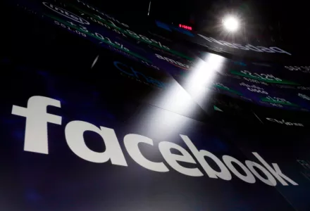 In this March 29, 2018, file photo the logo for Facebook appears on screens at the Nasdaq MarketSite in New York's Times Square. Facebook made $40 billion in advertising revenue last year. 