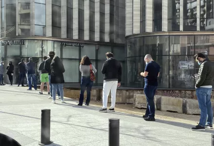People stand in a line outside a bank in Beirut, Lebanon, amid a financial crisis and a lockdown imposed by the government to help stem the spread of the coronavirus in Lebanon, March 28, 2020.