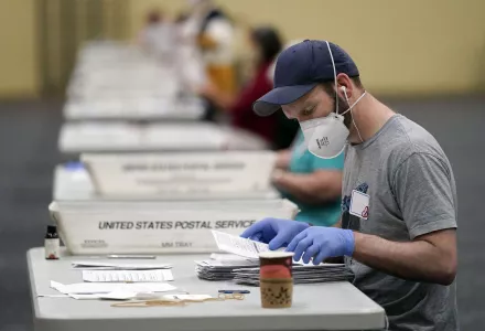 Workers prepare mail-in ballots for counting, Wednesday, Nov. 4, 2020, at the convention center in Lancaster, Pa., following Tuesday's election.