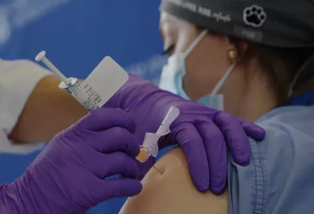 Catalina Gonzalez-Marques, an emergency medical physician, receives the Pfizer-BioNTech coronavirus vaccine at Brigham and Women's Hospital, Wednesday, Dec. 16, 2020, in Boston.