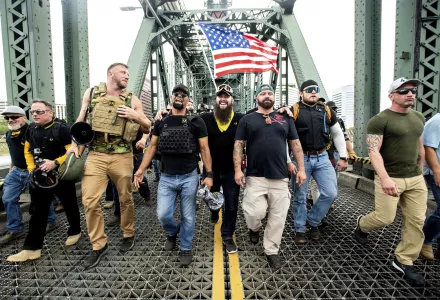 Photo of members of the Proud Boys, including organizer Joe Biggs, third from right, march across the Hawthorne Bridge during an "End Domestic Terrorism" rally in Portland, Ore., on Saturday, Aug. 17, 2019. Biggs was arrested Wednesday, Jan. 20, 2021 for taking part in the siege of the U.S. Capitol. 